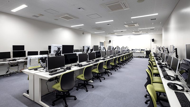 医療情報実習室の内部、複数のコンピュータと椅子が整然と配置されている様子。