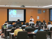 福島県立医科大学の講義室で、講師が学生に向けてプレゼンテーションを行っている様子。
