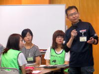 医療に関する研修会で講演する男性と参加者たち、福島県立医科大学の活動の一環。