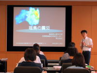 福島県立医科大学での講演会の様子。講師がスライドを使って東日本大震災について説明している。