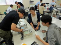 第2回福島災害医療セミナーで医療従事者が機器を操作しながら議論している様子。