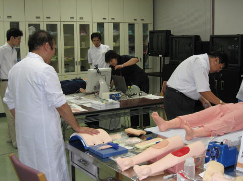 医療シミュレーションのデモ中、医師や学生が人形を使って実習している様子。