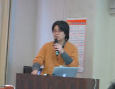 福島アドバンスド・コースで講演を行う男性がマイクを持ち、プレゼンテーションをしている様子。