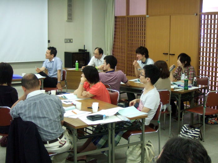 第1回診断推論セミナーで参加者が講義を受けている様子。テーブルには資料や飲み物が置かれ、真剣に話を聞く姿が見られる。
