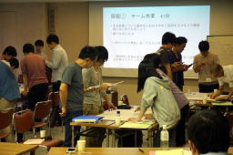 第8回診断推論セミナーで参加者がグループディスカッションを行っている様子。背景にはプレゼンテーションが映し出されている。