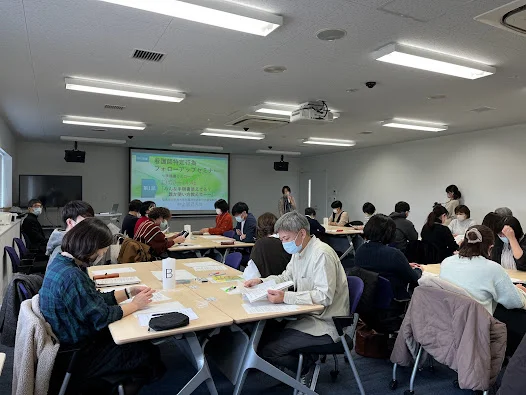 看護師特定行為研修のフォローアップセミナーで、参加者が資料を読みながら講義を受けている様子。