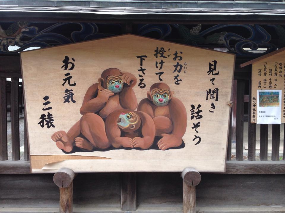 秩父神社にある「お元気三猿」の看板。三匹の猿が「よく見て・よく聞いて・よく話す」と表現されている。