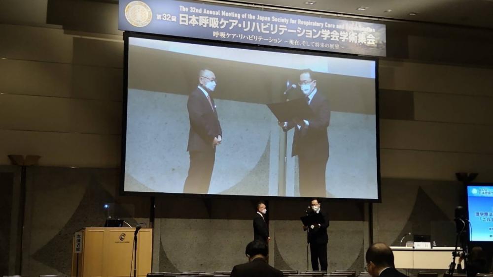 学会特別講演で感謝状を受け取る髙橋仁美教授と柴田陽光教授の様子。