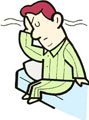 ベッドに座り、頭を抱える男性のイラスト。睡眠不足や疲労感を表現している。