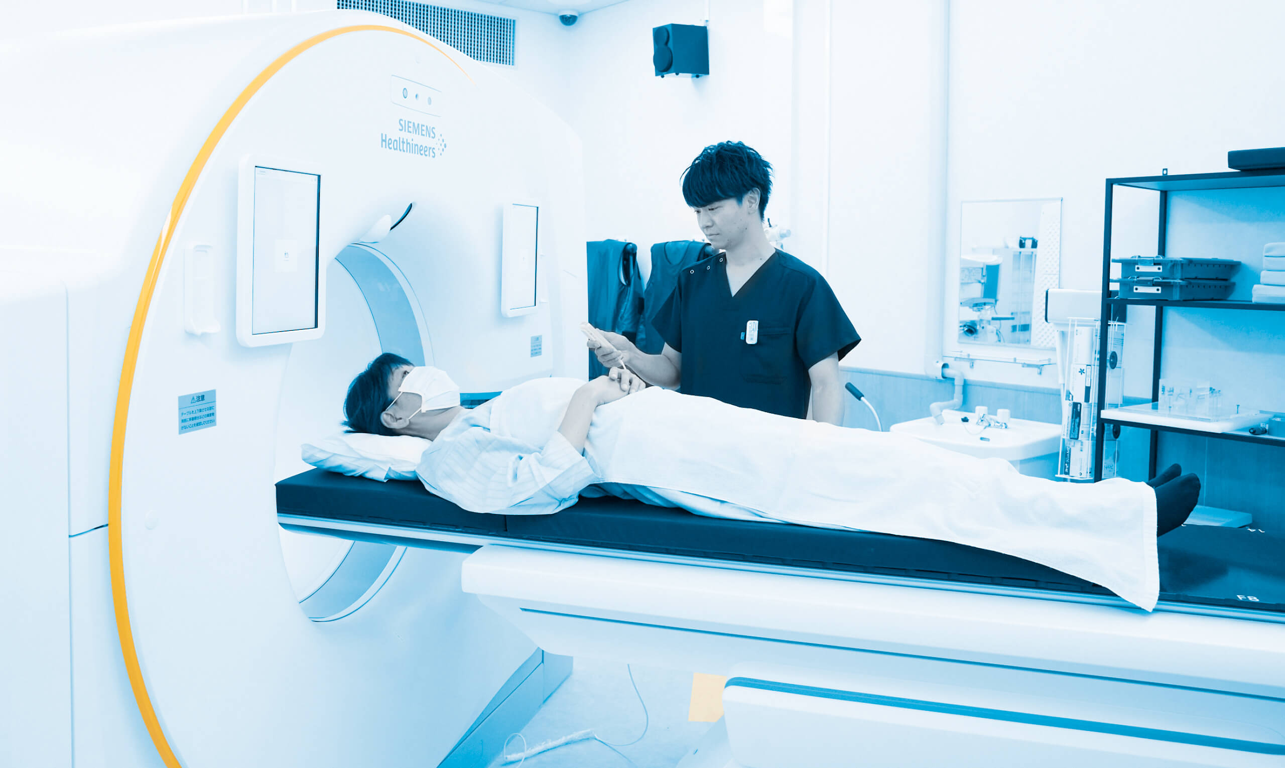 放射線治療を受ける患者と医療スタッフがいる診察室の様子。