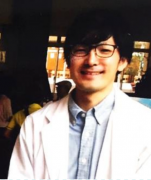 福島県立医科大学の講師、竹林由武氏が白衣を着て微笑んでいる写真。