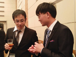 スーツ姿の二人の男性が談笑している様子。