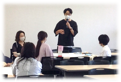 看護学実習に関する共有会で講演する男性と、聴講する女性たちがいる会議室の様子。