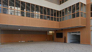 Entrance hall of Fukushima Medical University featuring wooden paneling and large windows.