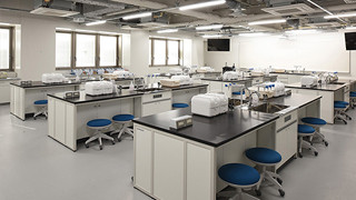 Analytic Chemistry Testing and Workshop Room with lab equipment and blue stools.