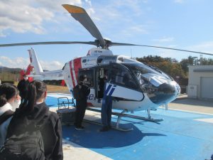 ふくしま国際医療科学センターでの中高生見学会の様子。ヘリコプターに乗り込む参加者たち。