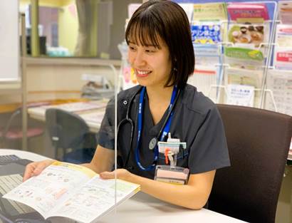 栄養管理部で集団栄養指導を行うスタッフが、資料を見ながら患者に説明している様子。