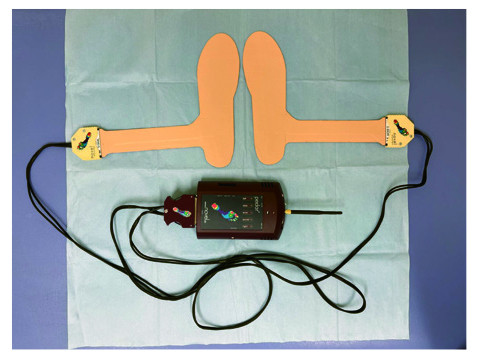 Insole-type pressure distribution sensors connected to a measurement device for analyzing plantar pressure during walking.