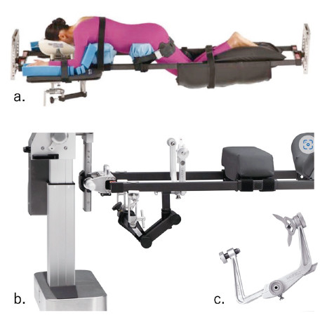 Skull clamp-assisted position on a modular operating table, featuring a patient lying face down with support equipment.