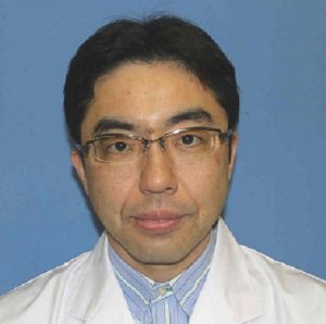 医療用白衣を着た男性のポートレート、背景は青色。