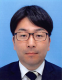 小名木彰史助手の公式プロフィール写真。ビジネススーツを着用し、真剣な表情でカメラを見つめている。